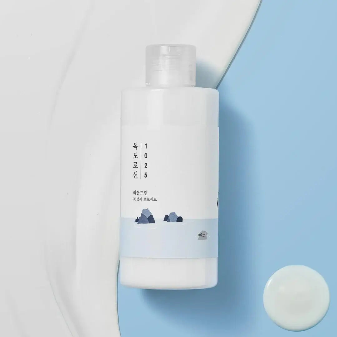 RoundLab 1025 Dokdo Lotion bottle on a blue background, a lightweight moisturizer with deep seawater minerals.