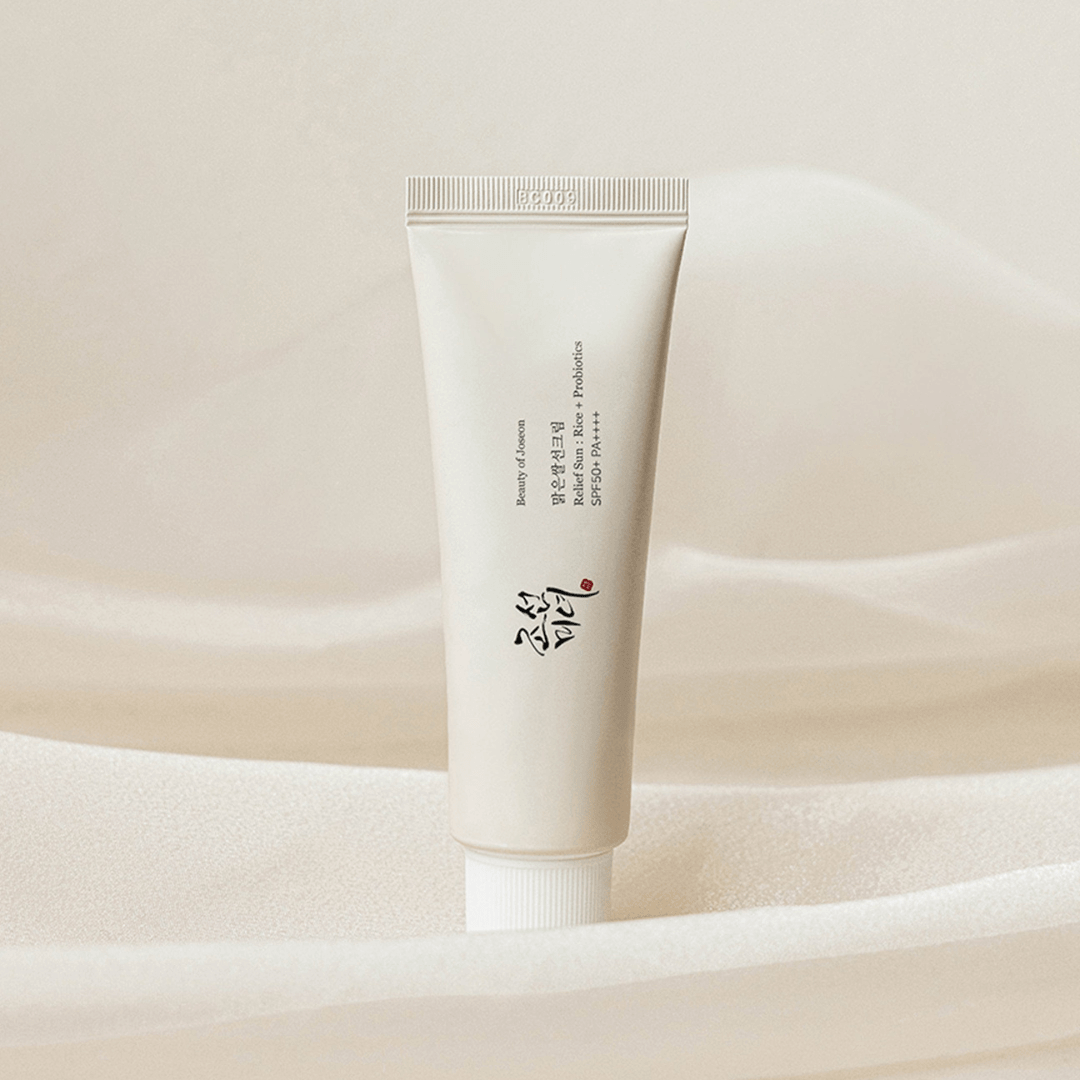 Beauty of Joseon Relief Sun Rice + Probiotic SPF50+ PA++++ tube on a soft fabric background.