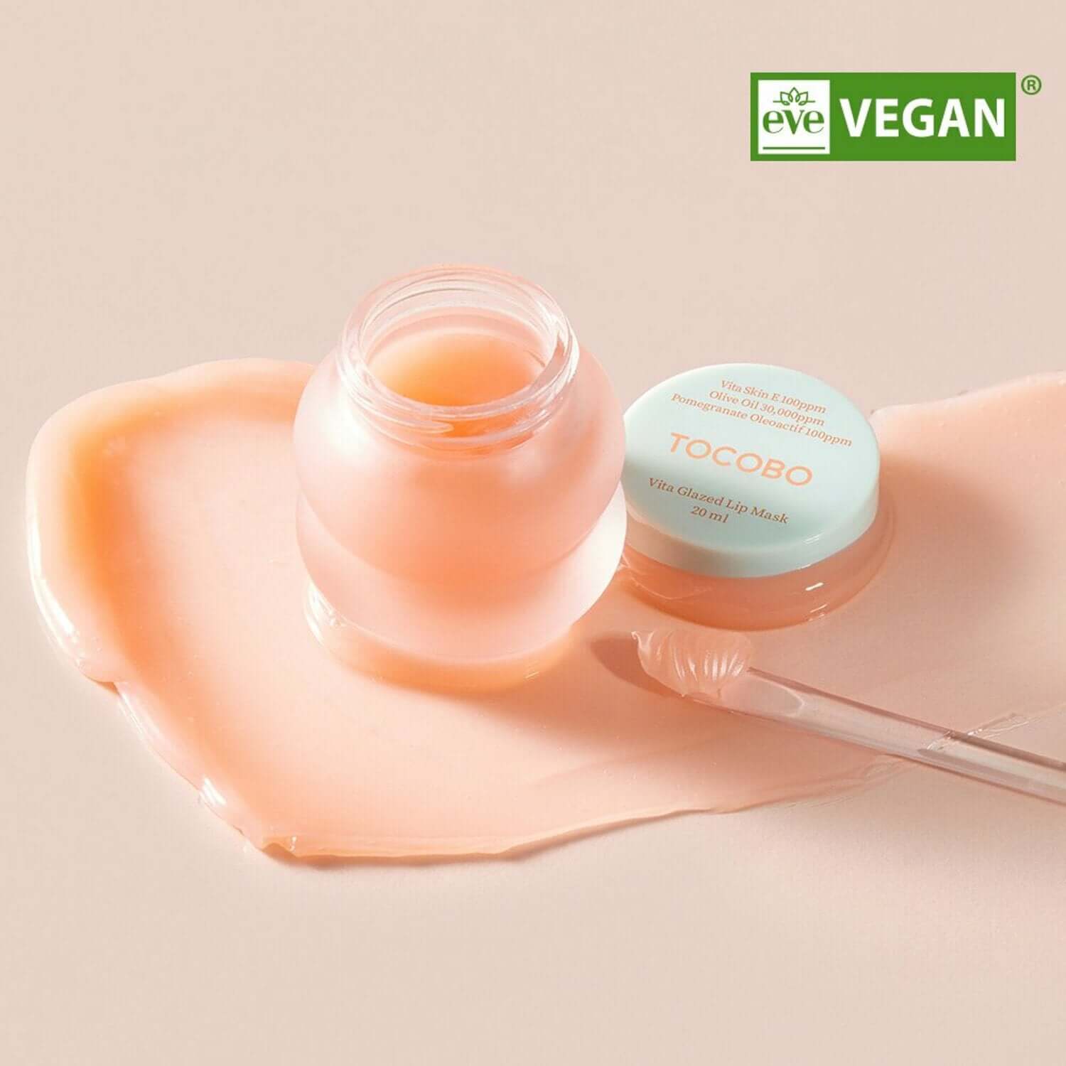 Tocobo Vita Glazed Lip Mask in jar with applicator, showcasing its vegan and hydrating formula on a glossy surface.