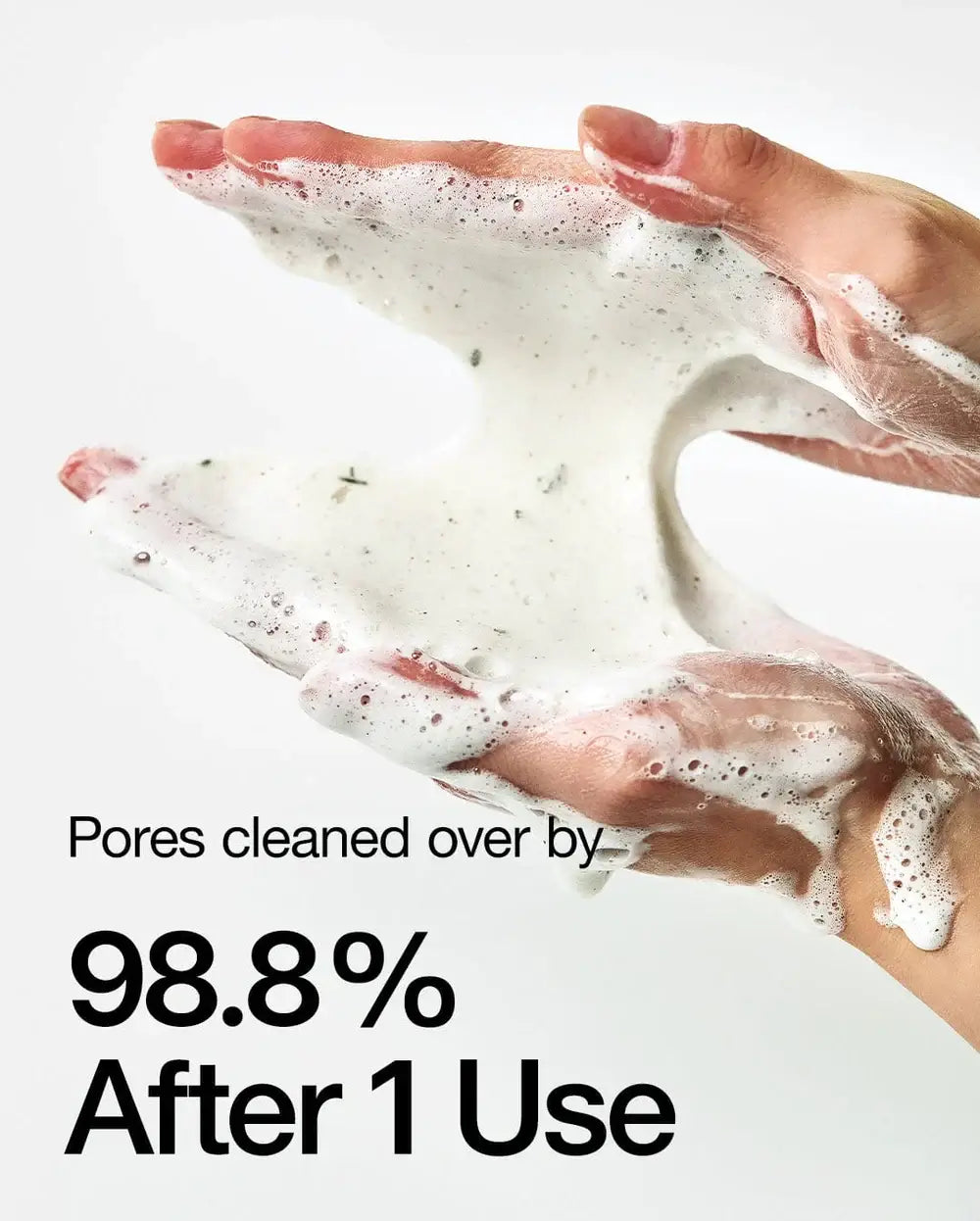 Hands holding foam cleanser showcasing 98.8% pore cleaning efficiency after one use.