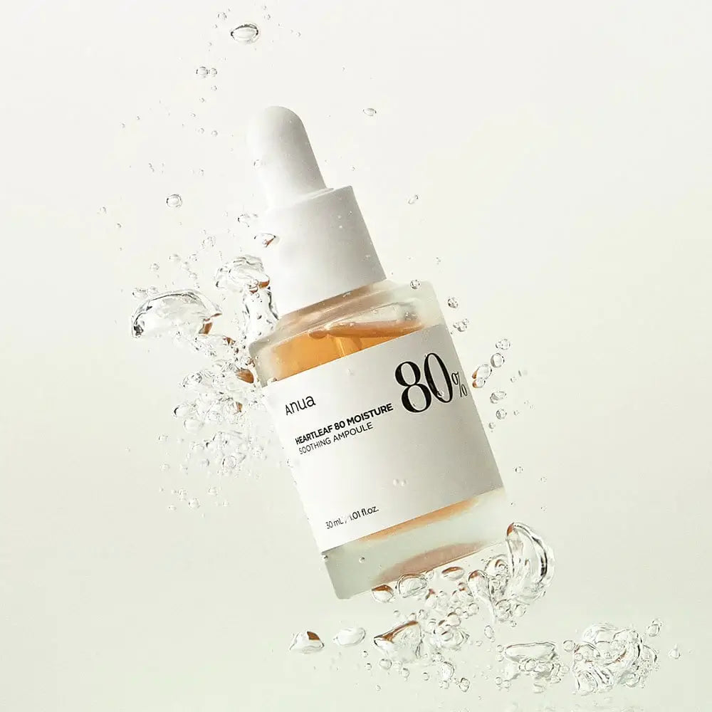 Anua Heartleaf 80 Moisture Soothing Ampoule bottle splashed with water for hydration benefits.