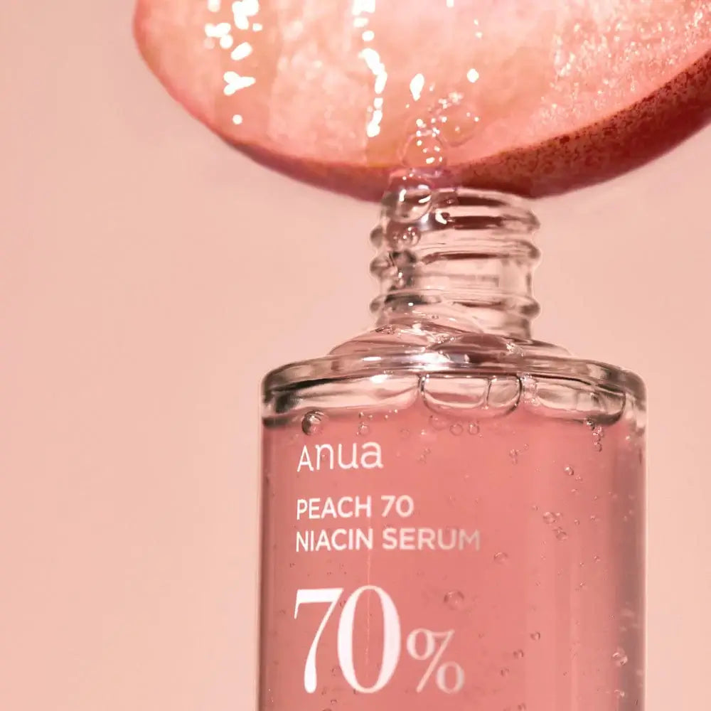 Anua Peach 70 Niacin Serum bottle with peach slice, promoting glowing skin and brightening effects.