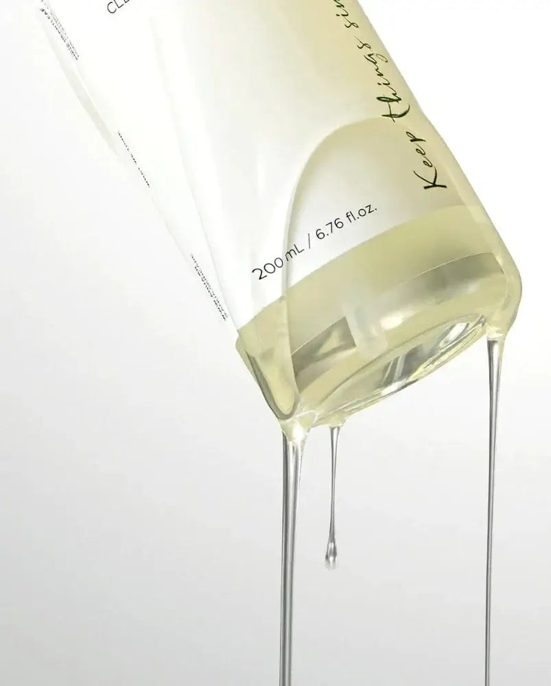 Anua Heartleaf Pore Control Cleansing Oil bottle pouring with oil drizzling down, perfect for sensitive skin.