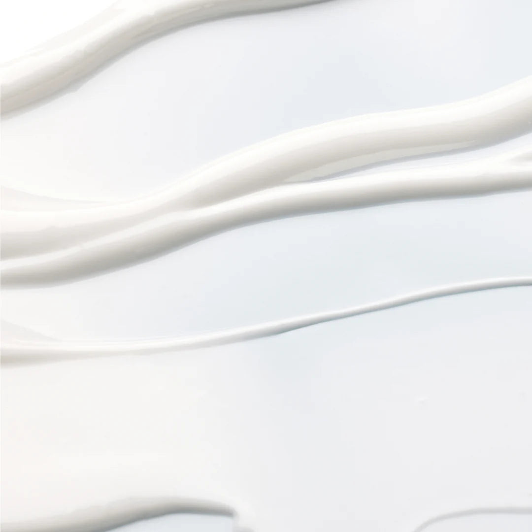 Close-up of smooth, white lotion texture showcasing its creamy consistency and hydrating properties.