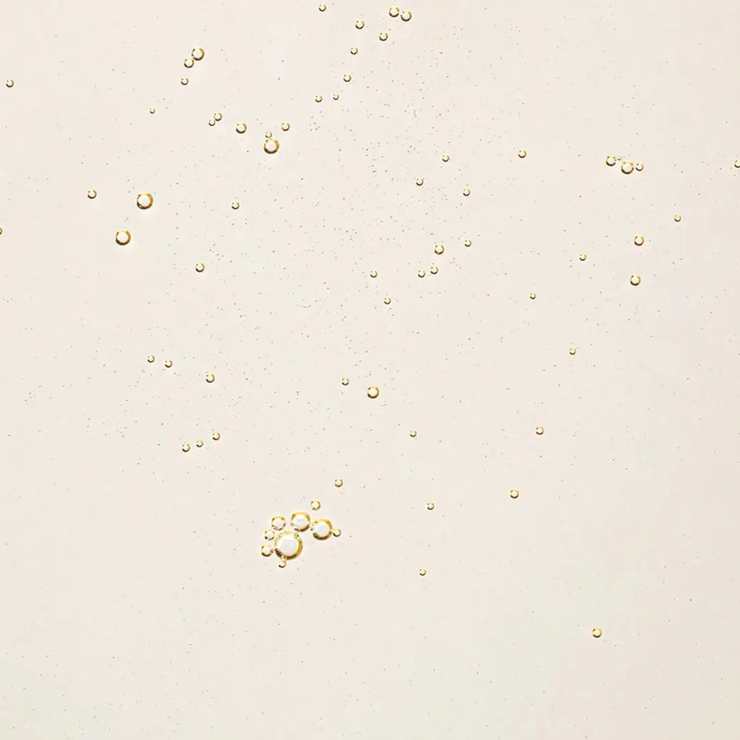 Close-up of golden bubbles in Beauty of Joseon Ginseng Cleansing Oil, showcasing its lightweight texture and cleansing properties.