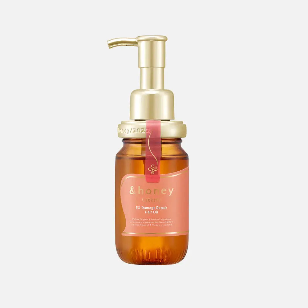 &Honey Creamy EX Damage Repair Hair Oil bottle with pump, enriched with honey and hyaluronic acid for deep hydration.