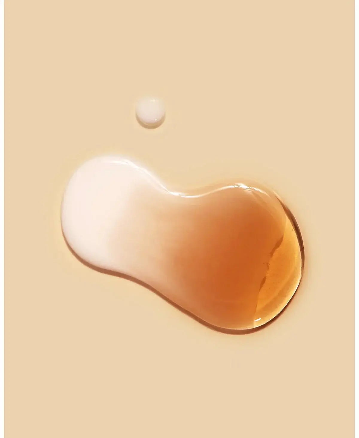 Dr. Ceuracle Vegan Kombucha Tea Essence droplets on a neutral background, showcasing the product's creamy texture.