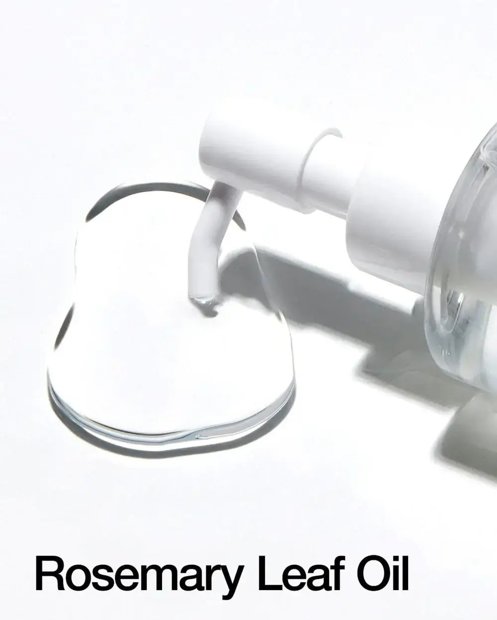 Close-up of rosemary leaf oil with a pump top, showcasing its lightweight texture and clarity.