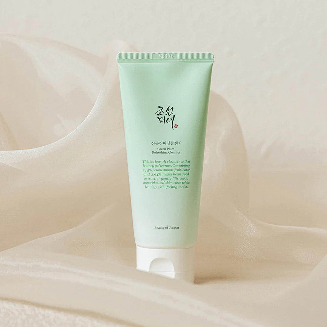 Beauty of Joseon Green Plum Refreshing Cleanser tube on soft fabric background, designed for clean, hydrated skin.