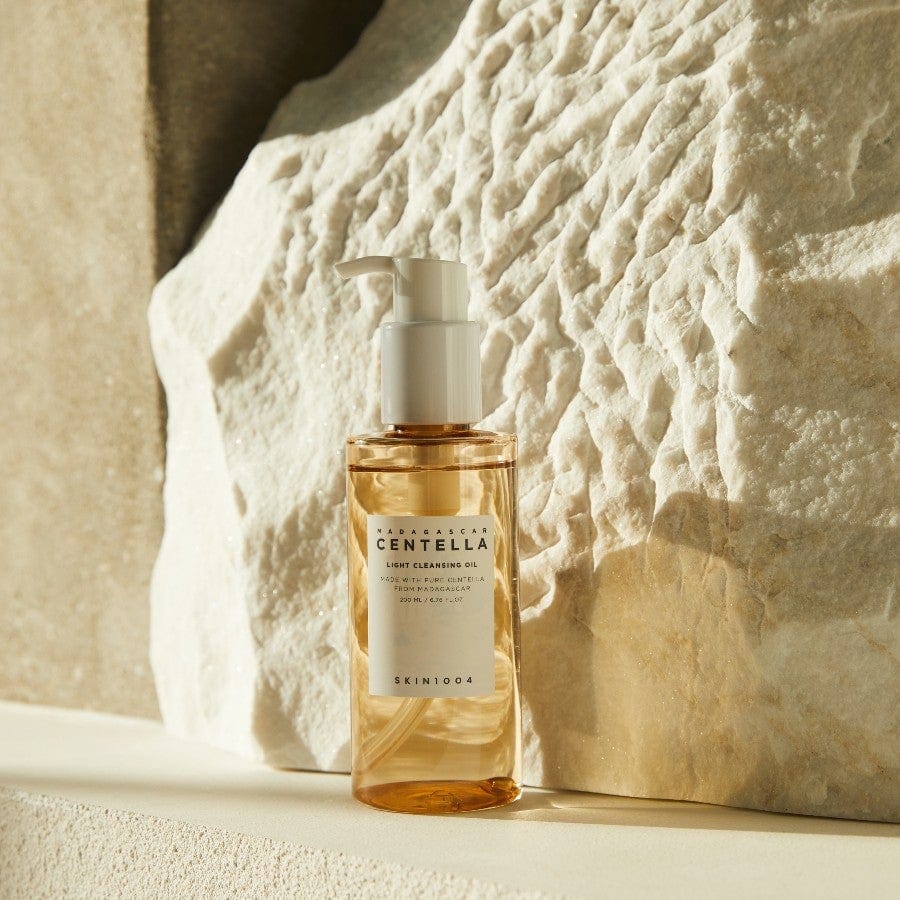 SKIN1004 Madagascar Centella Light Cleansing Oil on a textured stone background, perfect for gentle makeup removal.