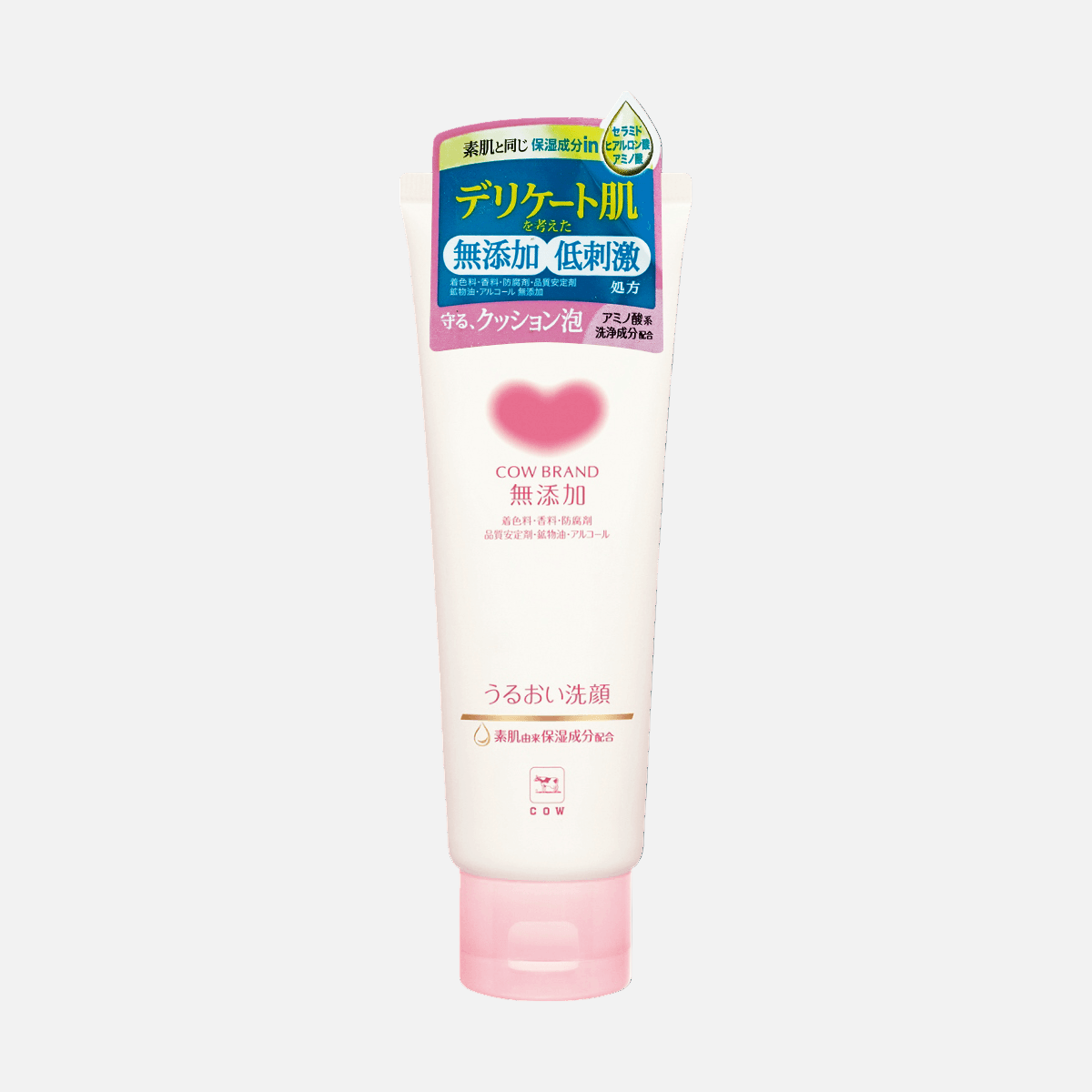 Tube of Cow Brand skincare product with pink cap on a dark blue background